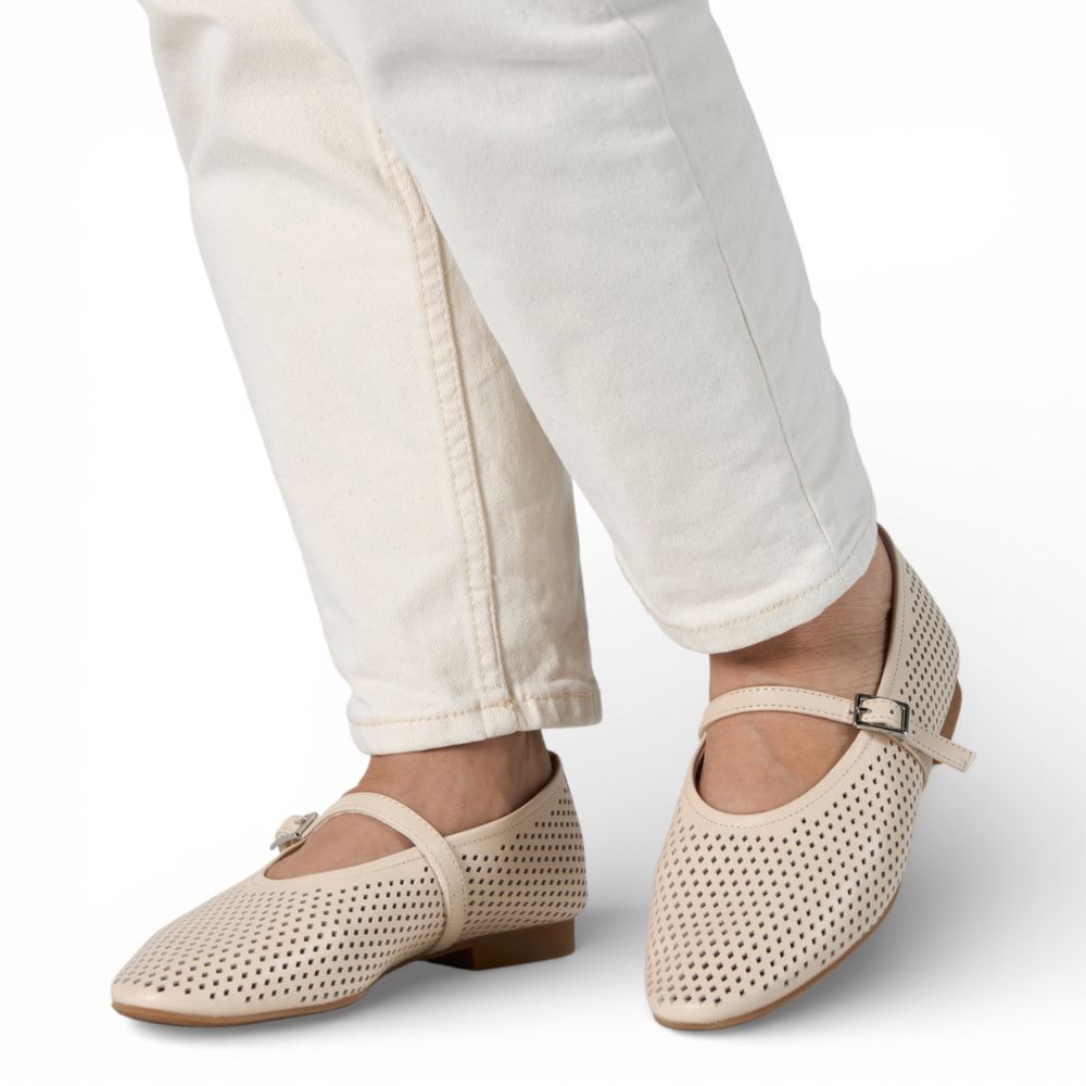 Richmond Bone Perforated Leather Mary Jane shoes worn with white pants on a light background