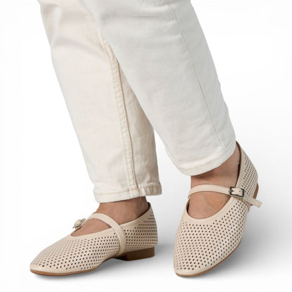 Richmond Bone Perforated Leather Mary Jane shoes worn with white pants on a light background