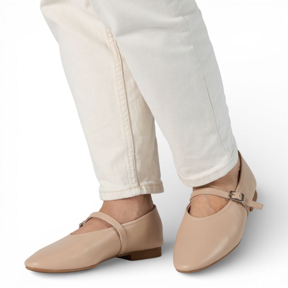 Richmond Cream Leather Mary Jane shoes worn with white pants on a light gray background