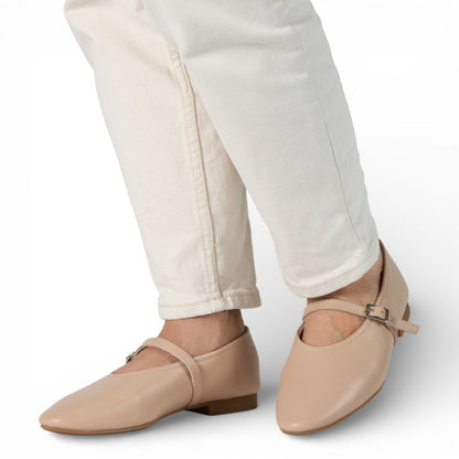 Richmond Cream Leather Mary Jane shoes worn with white pants on a light gray background