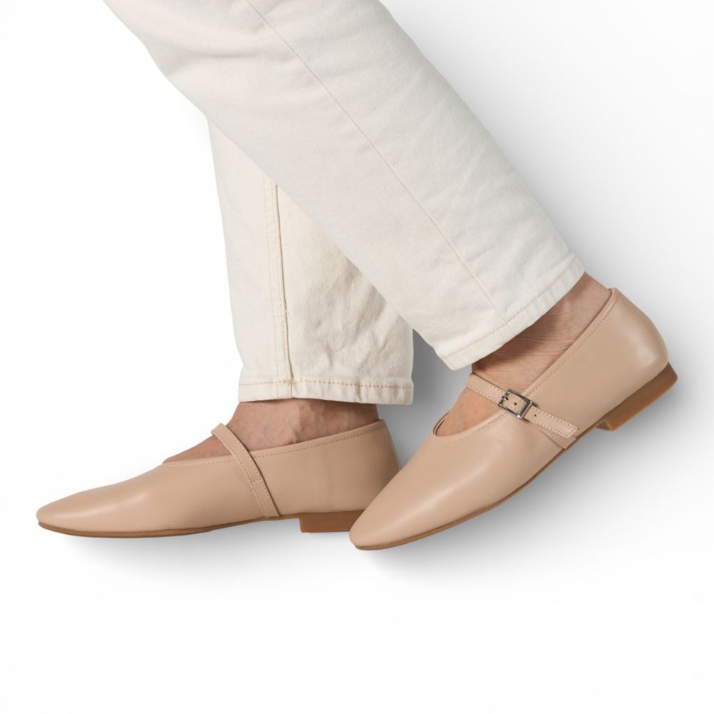 Richmond Cream Leather Mary Jane shoes worn with light-colored pants on a white background