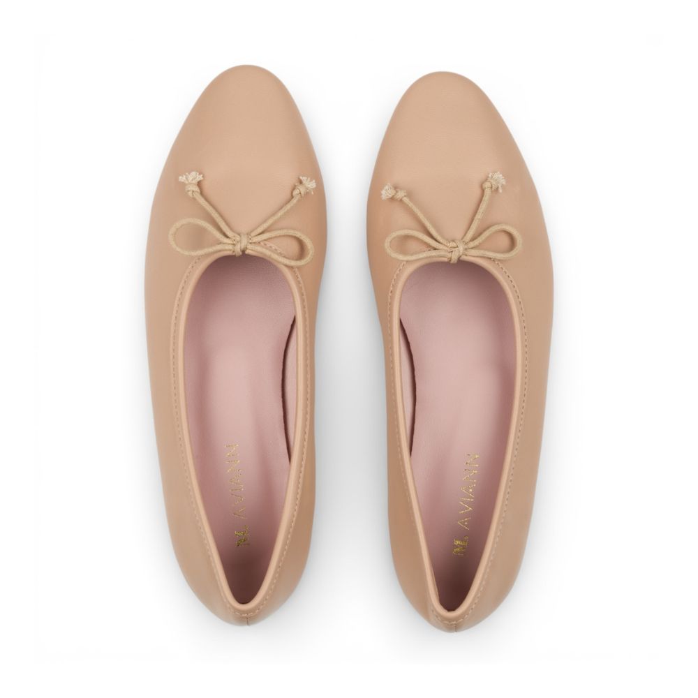 Pair of Roma Nude Leather Elegant Flat shoes with bow details on a white background