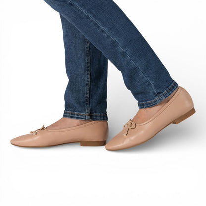 Roma Nude Leather Elegant Flat worn with blue jeans on a white background