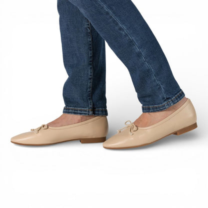 Roma Pearl Leather Elegant Flat worn with blue jeans on a white background