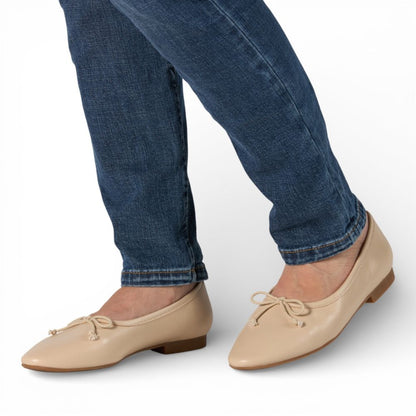 Roma Pearl Leather Elegant Flat worn with blue jeans on a white background