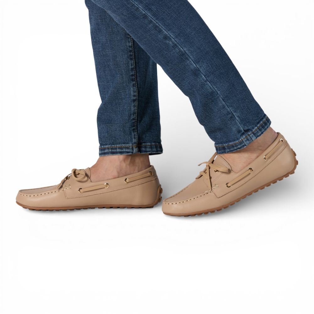 Sevilla Beige Leather Boat Moccasins worn with blue jeans on a white background