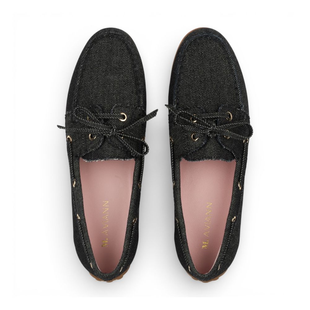 Pair of Sevilla Black Denim Boat Moccasins with pink insole on a white background