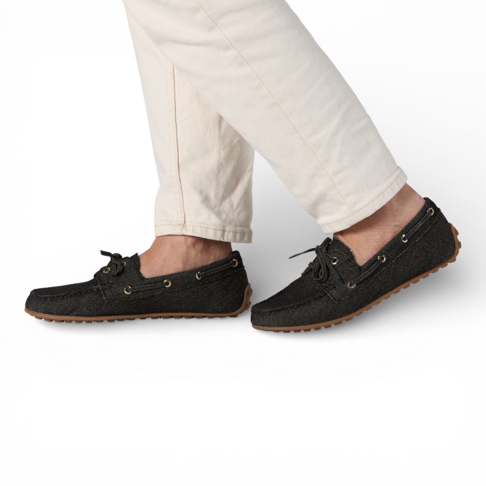 Sevilla Black Denim Boat Moccasins worn with light-colored pants on a white background