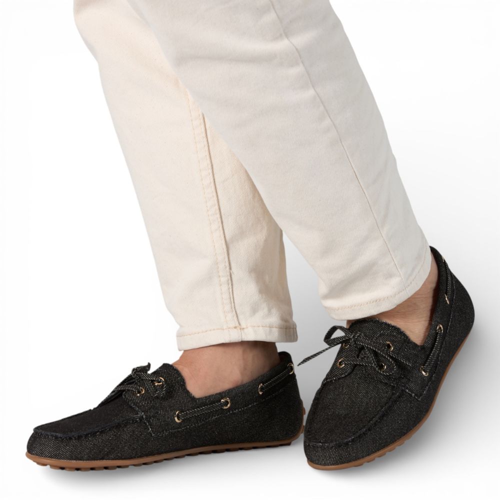 Sevilla Black Denim Boat Moccasins shoes worn with white pants on a light background