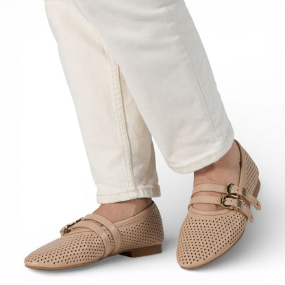 Dover Powder Perforated Leather Flat with Double Strap Detail with white pants on a light gray background